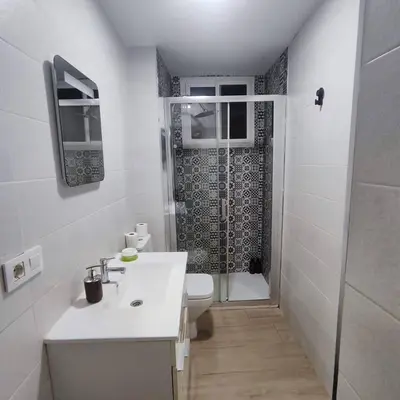 a bathroom with a toilet and a sink and a shower at Jacuzzi Amazonas Relax en el Corazón del Puerto in El Puerto de Santa María