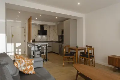 a living room with a gray couch and a kitchen at DELFIN Sunny Home by Cadiz4Rentals in Cádiz