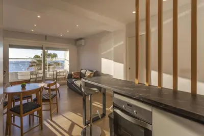 a kitchen and living room with a table and chairs at DELFIN Sunny Home by Cadiz4Rentals in Cádiz