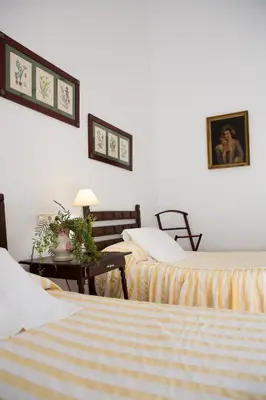 a hotel room with two beds and a table at CORTIJO RURAL LA MARISCALA in Jerez de la Frontera