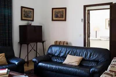 a black leather couch in a living room at CORTIJO RURAL LA MARISCALA in Jerez de la Frontera