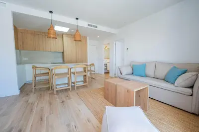 a living room with a couch and a table at Punta Candor Suites in Rota