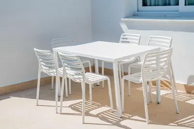 a white table with white chairs around it at Punta Candor Suites in Rota