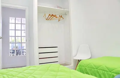 a bedroom with a green bed and a window at Chalet Cocle in Novo Sancti Petri