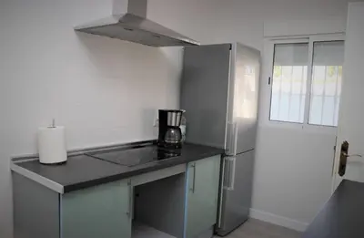 a kitchen with a sink and a refrigerator at Chalet Cocle in Novo Sancti Petri