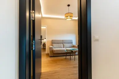 a door leading into a living room with a couch at Villa de Paradas in Cádiz
