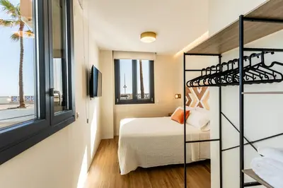 a small bedroom with a bunk bed and a bunk ladder at Villa de Paradas in Cádiz
