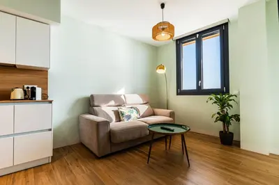 a living room with a chair and a table at Villa de Paradas in Cádiz