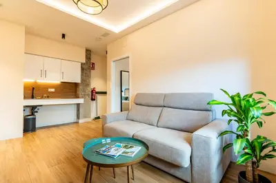 a living room with a couch and a table at Villa de Paradas in Cádiz