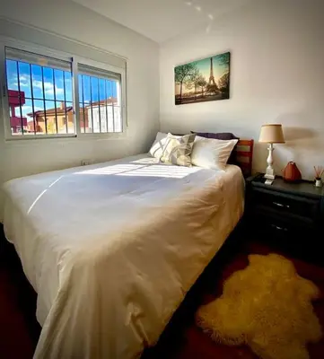 a large white bed in a bedroom with a window at MyChoice Villa Almadraba in Rota