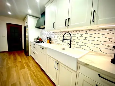 a kitchen with white cabinets and a sink at MyChoice Villa Almadraba in Rota