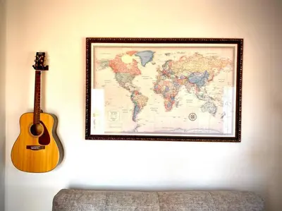 a map of the world with a guitar on a wall at MyChoice Villa Almadraba in Rota