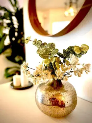 a vase with flowers in it sitting on a table at MyChoice Villa Almadraba in Rota