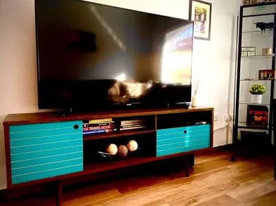 a entertainment center with a flat screen tv in a living room at MyChoice Villa Almadraba in Rota