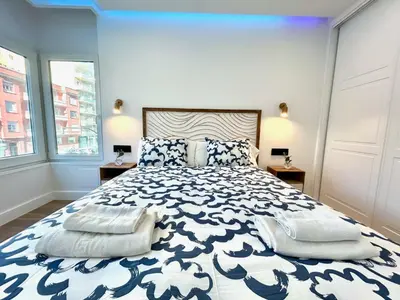 a bedroom with a large bed with two pillows at GATU PREMIUM Deseo Piso de Lujo con Parking 