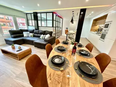 a living room with a wooden table and chairs at GATU PREMIUM Deseo Piso de Lujo con Parking 