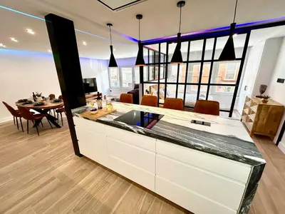 a kitchen with a sink and a dining room with a table at GATU PREMIUM Deseo Piso de Lujo con Parking 