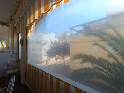 a view from a window of a building with a palm tree at Costa Ballena - El Paraíso in Rota