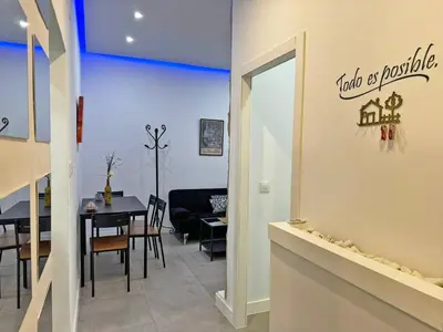 a dining room and kitchen with a table and chairs at Apartamento Acebuche - Ole Solutions in Jerez de la Frontera
