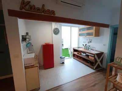 a kitchen with a red refrigerator in a room at LA CASA DE LAS BICIS in Cádiz