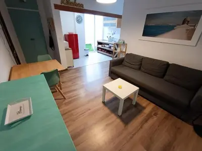 a living room with a couch and a table at LA CASA DE LAS BICIS in Cádiz