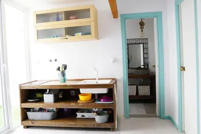 a bathroom with a sink and a counter and a mirror at LA CASA DE LAS BICIS in Cádiz