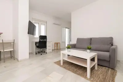 a living room with a couch and a table at Verano en Chiclana in Chiclana de la Frontera