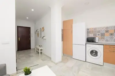 a kitchen with a washer and dryer in a room at Verano en Chiclana in Chiclana de la Frontera