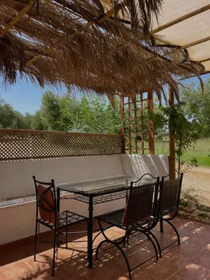 a table and two chairs sitting on a patio at casa entre mer et montagne in Arcos de la Frontera