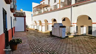 an alley between two buildings in a city at RESIDENCIAL VICTORIA CENTRO in Sanlúcar de Barrameda