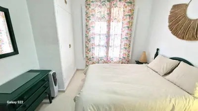 a small bedroom with a bed and a window at RESIDENCIAL VICTORIA CENTRO in Sanlúcar de Barrameda