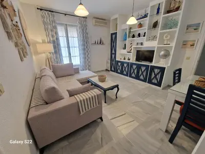 a living room with a couch and a table at RESIDENCIAL VICTORIA CENTRO in Sanlúcar de Barrameda
