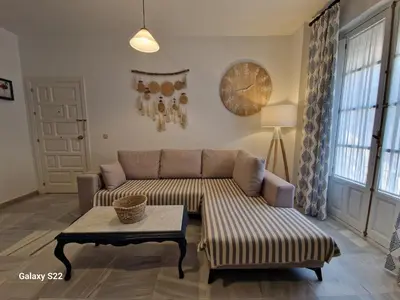 a living room with a couch and a table at RESIDENCIAL VICTORIA CENTRO in Sanlúcar de Barrameda