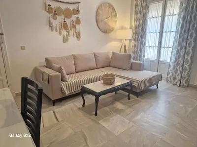 a living room with a couch and a table at RESIDENCIAL VICTORIA CENTRO in Sanlúcar de Barrameda