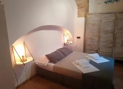 a bedroom with a bed with two lamps on it at La gota de leche 1 in Sanlúcar de Barrameda