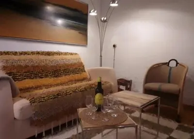 a living room with a bed and a couch and a table at La gota de leche 1 in Sanlúcar de Barrameda