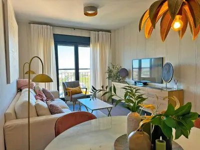 a living room with a couch and a table at Apartamento Moscatel - Ole Solutions in Jerez de la Frontera