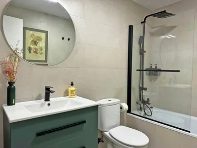 a bathroom with a toilet and a sink and a mirror at Apartamento Moscatel - Ole Solutions in Jerez de la Frontera