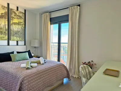 a bedroom with a bed and a large window at Apartamento Moscatel - Ole Solutions in Jerez de la Frontera