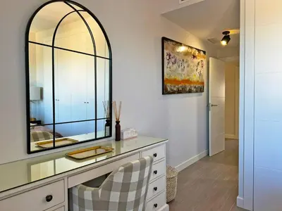 a dressing room with a mirror and a dresser at Apartamento Moscatel - Ole Solutions in Jerez de la Frontera