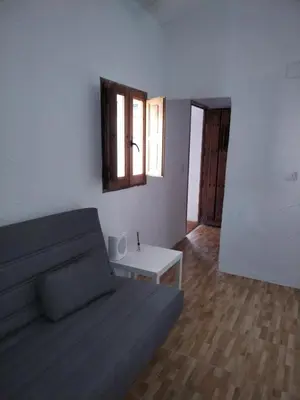 a living room with a couch and a table at APARTAMENTO CAMPANA-6 in Jerez de la Frontera