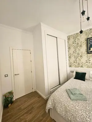 a bedroom with a bed with yellow pillows at Paraíso Malecón de Cádiz in Cádiz