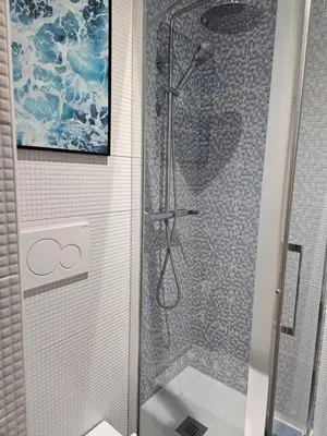 a bathroom with a shower with a glass door at Paraíso Malecón de Cádiz in Cádiz