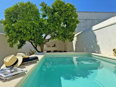 a swimming pool with two chairs and a tree at Casa Leopoldo - Ole Solutions in Bornos