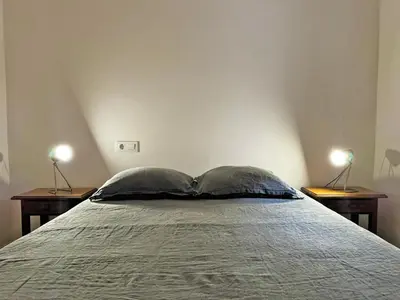 a bedroom with a bed with two lamps on two tables at Casa Leopoldo - Ole Solutions in Bornos