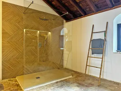 a shower with a glass door in a bathroom at Casa Leopoldo - Ole Solutions in Bornos