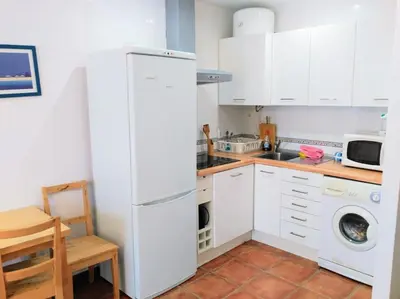 a kitchen with white cabinets and a white refrigerator at Piscina y garaje a 300 m de playa OJO VER CORREO NO DESEADO SI NO LLEGA RESPUESTA in Rota