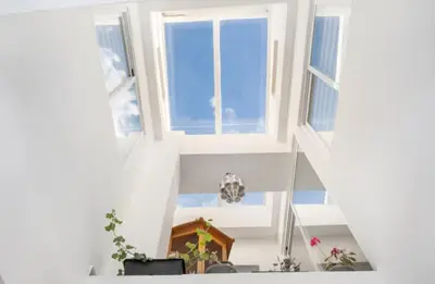 a room with white walls and windows at APARTAMENTO BRIANNA in Jerez de la Frontera