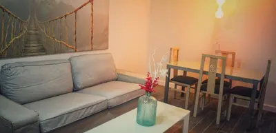 a living room with a couch and a table at APARTAMENTO BRIANNA in Jerez de la Frontera