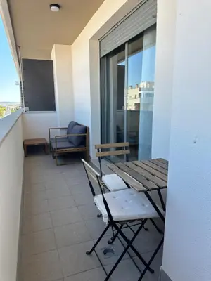 a table and chairs in a room with a window at Apartamento Jardín de Cano - Preferente familias y mayores de 25 años in El Puerto de Santa María